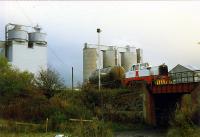 An industrial shunter doing some light shunting at Castle Cement, Gunnie. Gunnie Yard (out of shot to the right reached by a fly-over) became the exchange sidings for the cement works. The (now) closed cement works was the only part of Bairds Iron and Steelworks to remain.<br><br>[Ewan Crawford /12/1989]