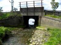 Bridge taking the line over a stream running south into the Clyde at Craigendoran. The abandoned original arched structure can be seen beyond. 28 May 2007.<br><br>[John McIntyre 28/05/2007]