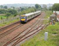 A westbound Edinburgh - Glasgow shuttle passing the site of Manuel station in July 2007. Originally opened as Bo'ness Junction in 1842, the station was eventually closed in March 1967. The line to Boness, now owned and operated by the SRPS, can be seen on the left beyond the wire fence.<br><br>[John Furnevel 07/07/2007]