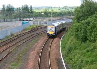 A Newcraighall train eastbound shortly after leaving Bathgate on 26 June 2006. The DMU is passing the entrance to a sparsely populated Bathgate Car Terminal.<br><br>[John Furnevel 26/06/2007]