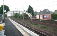 Sunday morning scene at Hillington East on 20 May 2007 looking towards Glasgow, with the Cardonald flats visible in the background below the footbridge.<br><br>[John Furnevel 20/05/2007]