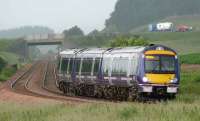 An Aberdeen express rounds the long curve at Bardrill north east of Blackford as a Relay truck heads south on the A9 with a car and caravan.<br><br>[Brian Forbes 30/06/2007]