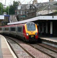 Edinburgh - Manchester Piccadilly service arrives at Haymarket platform 4 on 5 July. The tenements of Dalry Road form the backdrop.<br><br>[John Furnevel 05/07/2007]