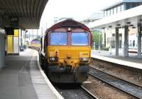 A pair of class 66 locomotives taking an empty ballast train from Waverley past the coffee kiosk on Haymarket platform 2 on 6 July 2007. The train turned south onto the <I>sub</I> at Haymarket Central Junction. <br><br>[John Furnevel 06/07/2007]