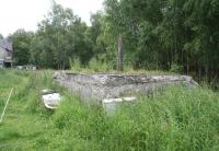 The remains of the goods yard just west of the main station at Alyth Junction in the summer of 2007, showing the old crane plinth and pivot, with the former stationmaster's house still standing in the left background [see image 15943].<br><br>[John Furnevel 12/07/2007]