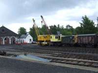 Recovery cranes and goods vans outside Aviemore Shed. The cranes were at one time a fixture at the MOD Boom Defence Depot at Fairlie<br><br>[Graham Morgan 06/07/2007]