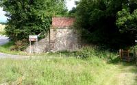 View north on the Gleneagles - Crieff line in July 2007 showing the remaining abutment of the bridge via which the line reached Tullibardine station standing just beyond the trees.<br><br>[John Furnevel 12/07/2007]