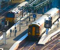 SWT liveried 158786 leaves Waverley platform 18 in bright early morning sunshine on 28 July passing 67022 waiting to depart with a (very) late running portion of the Highland Sleeper at platform 19.<br><br>[John Furnevel 28/7/2007]