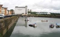 View north over the harbour in July 2007 showing the former branch coming in behind the mill and running out onto the railway arches. On the left is some of the new housing built within the old harbour area.<br><br>[John Furnevel 22/07/2007]