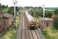 A Royal Mail 325 southbound through Gretna Junction in August 2007. The train is about to pass the old Gretna station building standing on the left.<br><br>[John Furnevel 03/08/2007]