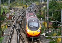 As the rain starts to fall on 3 August a southbound Pendolino is photographed straddling the border as it crosses the River Sark at Gretna.<br><br>[John Furnevel 03/08/2007]