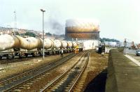 A class 26 assembles a cement train at Camperdown Junction in 1989. The train is on the siding that once ran down the side of Dundee East station, the lines in the foreground run to Dundee station via Dock Street Tunnel.<br><br>[Ewan Crawford //1989]