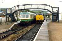 Meeting of two 37 hauled trains. The DMU on the left was converted to form an observation car. At the time Dingwall was a terminus.<br><br>[Ewan Crawford //1989]