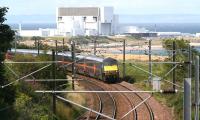 An up ECML express rounds the curve north of Cockburnspath on 16 August, dwarfed by Torness nuclear power station standing on the north side of the bay.<br><br>[John Furnevel 16/08/2007]