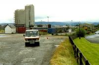 Minibus takes passengers from Muir of Ord to Dingwall to connect with a train. Passengers from Inverness took a different bus. This is while the Ness Viaduct was being replaced and the goods yard here in use as a depot.<br><br>[Ewan Crawford //1989]