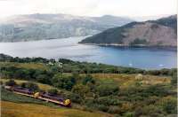 Two 37s work their way north with the old style alumina tanks for Fort William. Overlooking Loch Long and Portincaple.<br><br>[Ewan Crawford //1989]