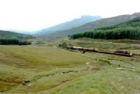 Northbound freight Climbing to County March Summit from Tyndrum Upper.<br><br>[Ewan Crawford //1989]