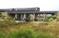 The 1051 Inverness - Edinburgh service crossing the last remaining timber bridge on a main line railway in Scotland approaching Moy on 1 September 2007.<br><br>[John Furnevel 01/09/2007]