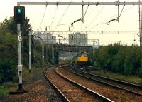 Squeal, grind, squeal. 26 comes slowly out of the Ladyburn sidings with a molasses train from James Watt Dock. View from Bogston station.//16472,16476,16474,16475,16455,16477<br><br>[Ewan Crawford //1988]