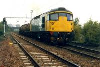 Finally free of the sidings, a molasses train from James Watt Dock accelerates east through Bogston on the way to Menstrie. Any grain wagons for Cambus will be added at Stirling.//16472,16476,16474,16475,16455,16477<br><br>[Ewan Crawford //1988]