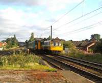 South end of Leyland on 26 August with a 156 departing for Liverpool passing a Blackpool North service arriving at the station.<br><br>[John McIntyre 26/08/2007]