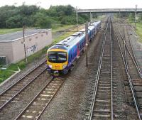 185122 heading south from Preston on the up slow line at Farington Junction on 6 July with a service to Manchester Airport.<br><br>[John McIntyre 06/07/2007]