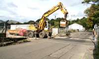 A roadrail vehicle takes a ballast truck east over Cambus level crossing on 13 September 2007.<br><br>[John Furnevel 13/09/2007]