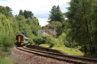 Inverness train speeds past The Mound station in July 2004 seen from the goods loading bank at the south end. The former Dornoch branch platform is on the right.<br><br>[Ewan Crawford /07/2004]