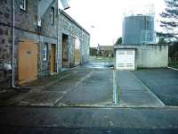 The rear bay of Dallas Dhu distillery in April 2007 showing the two sidings still embedded in the road surface.  The trackbed exists behind the silo to the right of the frame.<br><br>[Matthew Tomlins /04/2007]