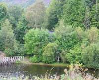 On leaving The Mound the Dornoch branch turned sharply south, crossing upper Loch Fleet via a bridge onto the causeway [See image 9211]. Looking north across the narrows from the causeway on 31 August the top of the surviving bridge abutment can just be seen amongst the trees.<br><br>[John Furnevel 31/08/2007]