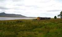 A northbound train on the shores of Loch an Ruathair in August 2007 on the section between Kinbrace and Forsinard.<br><br>[John Furnevel 27/08/2007]