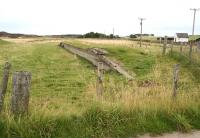 The platform remains at Skelbo alongside the former level crossing in 2007 looking south towards Dornoch. <br><br>[John Furnevel 26/8/2007]