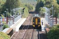 A Falkirk Grahamston - Glasgow Queen Street service stands at Gartcosh station on 25 September 2007. Gartcosh Junction can be seen in the centre background. [See image 2698]<br><br>[John Furnevel 25/09/2007]