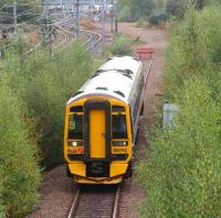 158710 leaves the reversing siding at Millerhill to form the next Newcraighall - Waverley service on 8 October while the freight in the background waits for it to clear the section to Niddrie South Junction.<br><br>[John Furnevel 08/10/2007]