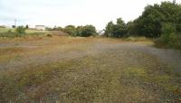 Part of the remains of the once extensive yards of Bilston Glen Colliery, closed in 1988. At its peak the pit employed 2,300 men and topped Scottish coal production figures, with the majority of the annual tonnage supplied by rail to Cockenzie power station. The Roslin branch entered centre picture (near the new housing) and continued via the gap in the trees on the right onto Bilston Glen viaduct and on towards Roslin. No trace of the colliery itself remains today with the site now occupied by industrial and commercial premises including the Lothian and Borders Police Communications Centre.<br><br>[John Furnevel 03/10/2007]