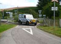 Gone completely off the rails..! After raising its flanged wheels a roadrail vehicle drives off the level crossing at Kildonan on 27 August. <br><br>[John Furnevel 27/8/2007]