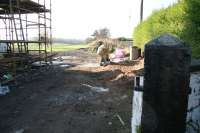 Road entrance to the former goods yard at Crook of Devon in October 2007 with a surviving gatepost on the right. The station and level crossing stood off to the left behind the new construction currently underway on the site. The trackbed follows the line of the fence in the background west towards Rumbling Bridge and Alloa.<br><br>[John Furnevel 23/10/2007]