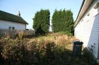 View northwest along the overgrown trackbed at Loch Leven on 23 October. Both of the whiteboard-fronted platform buildings are still in use. The station closed to passenger traffic in 1921.<br><br>[John Furnevel 23/10/2007]