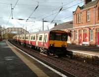 A 6-car class 318 on a Glasgow Central service arrives at Johnston station on 10 November.<br><br>[David Panton 10/11/2007]