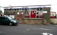 View northeast across the car park at Alexandria on 9 September with a train for Balloch standing at the platform.<br><br>[John Furnevel 09/09/2007]