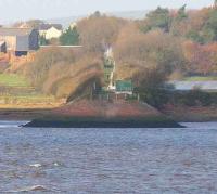 Standing at the end of the embankment at Bowness-on-Solway on 6 November 2007 looking north across the border to the shoreline at Annan. After clearing the northern embankment the line climbed to Shawhill Junction which gave a choice of G&SW or Caledonian routes north. On the right of the trackbed is the pipeline built to carry waste water down to the Solway from Chapelcross nuclear power station.<br><br>[John Furnevel 06/11/2007]