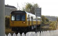 The driver of an eastbound class 142 reaches out of his cab window at Barkerhouse Road level crossing, Nelson, on 8 November in order to activate the barrier control. [See image 17268]<br><br>[John McIntyre 08/11/2007]