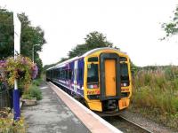 Gleaming refurbished 158701 at Alness. September 2007.<br>
The flowers in the baskets have been selected to match the train sets?<br><br>[Brian Forbes /09/2007]