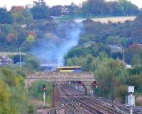 No train! A Deltic with a northbound special is obscured by a City Link coach on Edinburgh Road Bridge, Perth on 6 October. Does the sportsfield on the hillside belong to a High School? So much for preparation. Still the trackwork is interseting.<br><br>[Brian Forbes 06/10/2007]