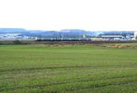 A train for Waverley heads south from the Forth Bridge past Edinburgh airport on 15 November 2007. The former Turnhouse station (closed 1930) was off to the right, while a new station is to be sited further south. This new station, which will provide train/tram interchange facilities, is to be called Edinburgh Gateway.<br><br>[John Furnevel 15/11/2007]