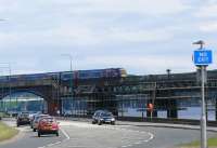 A <I>Commonwealth Games 2014</I> Turbostar about to pass through the former Esplanade station after reaching the Dundee end of the Tay Bridge, despite the road sign.<br><br>[Brian Forbes /08/2007]