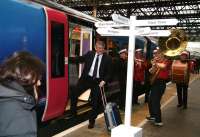 First Group CEO Moir Lockhead is serenaded aboard the FTPE special to Glasgow Central at Waverley on 4 December 2007 celebrating the launch of the First TransPennine Express services linking Edinburgh and Glasgow with Manchester Airport. [The names on the signpost refer to locations featured in a talk by travel journalist Simon Calder at the pre-launch bash in a well known local hotel.]<br><br>[John Furnevel 04/12/2007]