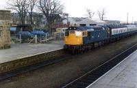 The early 1980s was an interesting period on the Aberdeen - Inverness line. The Swindon DMUs had been replaced with refurbished Mark 1 stock, usually hauled by the likes of 27006 (or 27008?) as in this view. Behind the trees can be seen the remains of Inverurie Loco Works (now a Tesco). Some other works buildings do still remain, namely the workshops in the distance above the coaches, albeit in a poor state.<br><br>[John Williamson //1981]