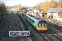 View northwest from Spout Lane road bridge on 4 November with a Saltburn - Bishop Auckland train running towards Shildon station. The station stands alongside the old S&D coal drops which are now incorporated within the NRM site. The line running up to the gate in the foreground gives rail access to the main exhibition hall and associated sidings on the other side of the road bridge.<br><br>[John Furnevel 04/11/2007]