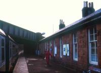 View northwest along the platform at Bridge of Weir towards Kilmacolm with a Glasgow bound service about to depart.<br><br>[Ian Dinmore //]
